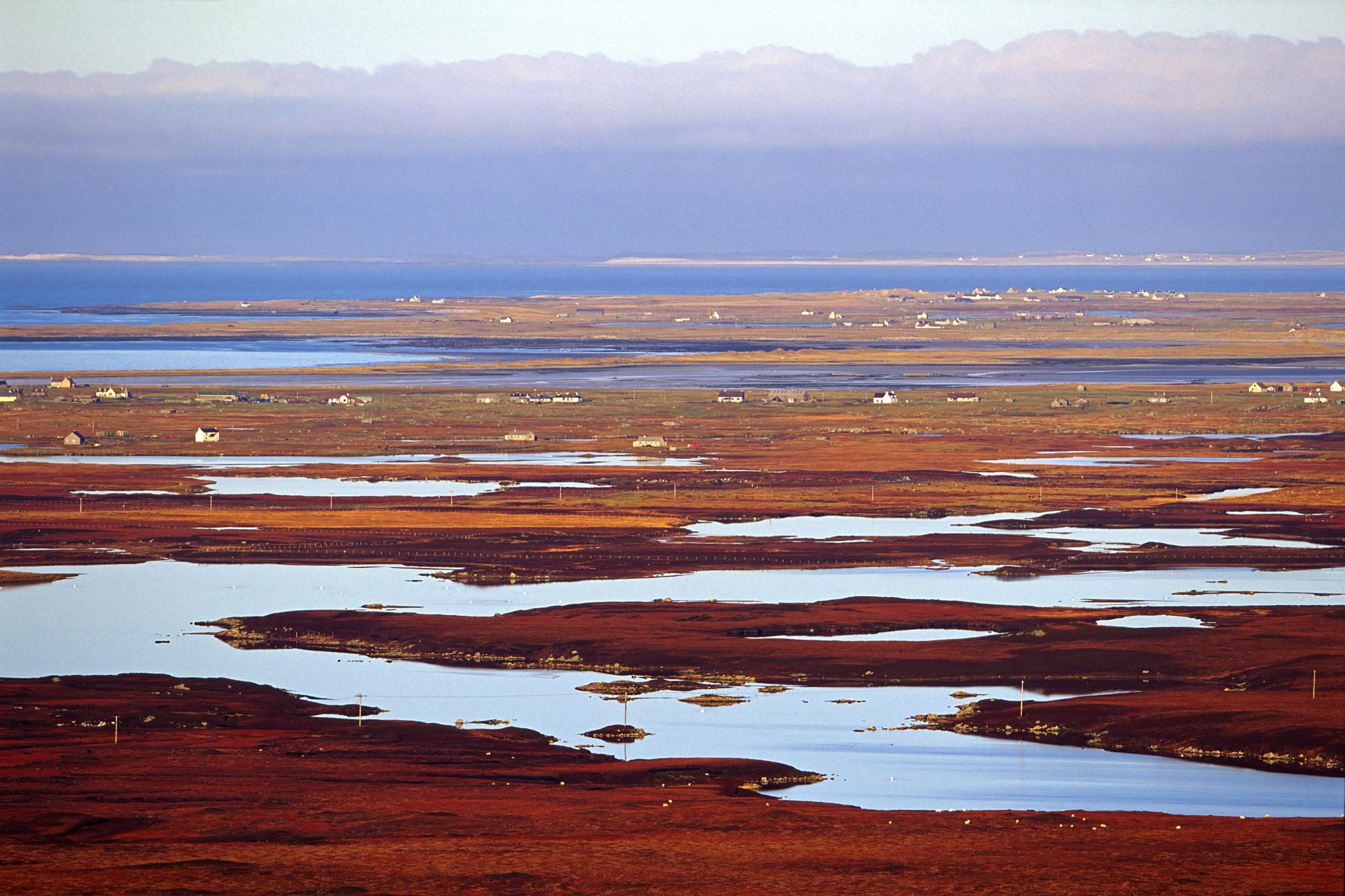 View north west across the peatland lochs and machair of South Uist and Benbecula.